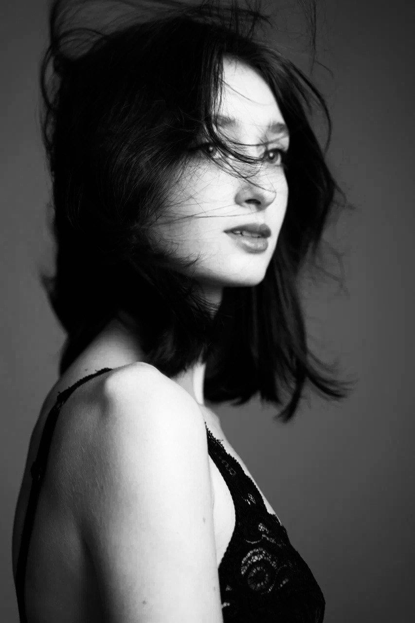 Black and white portrait of Arina Mura with windswept hair