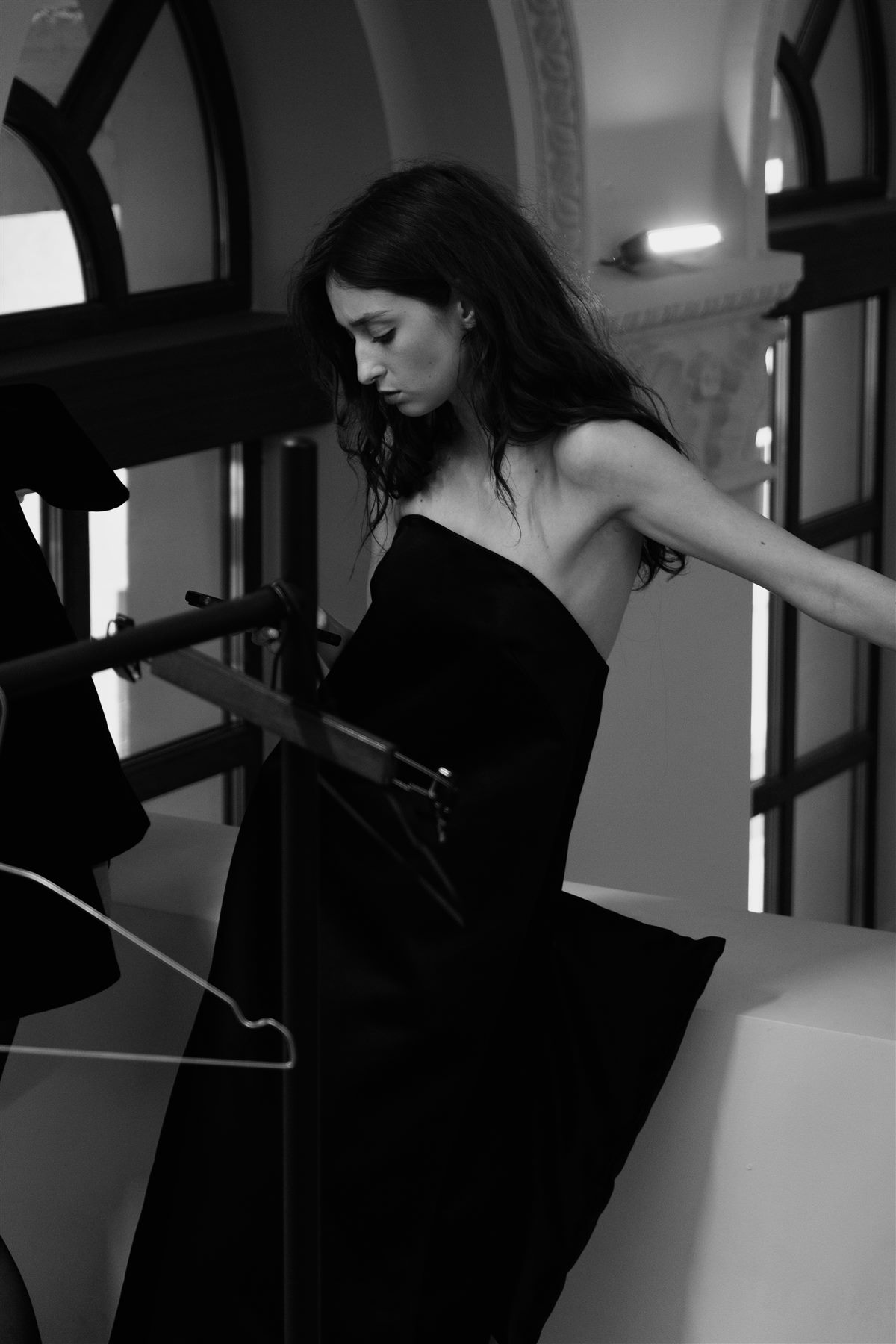 Arina Mura in a black strapless gown, indoor fashion portrait