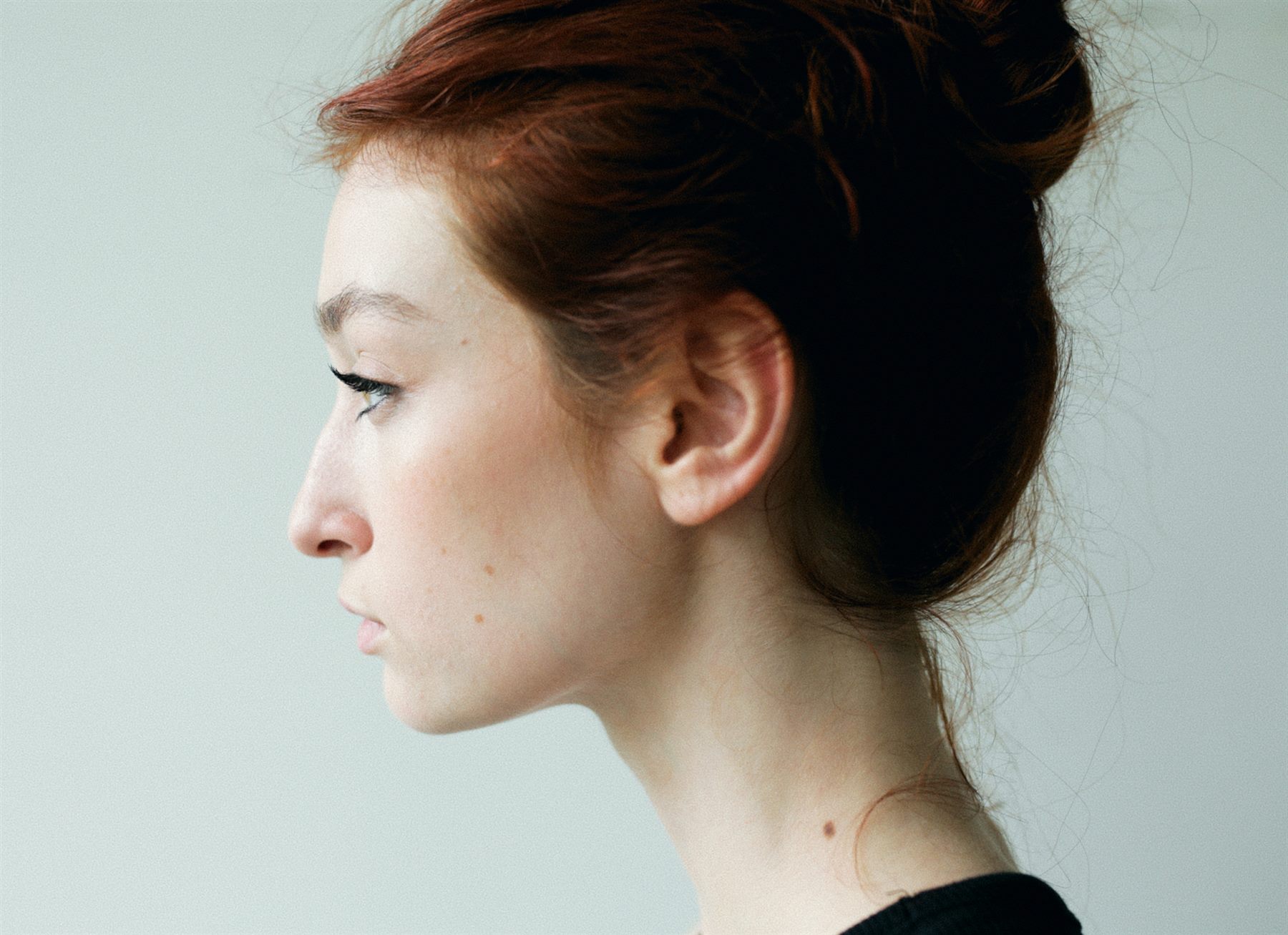 Arina Mura profile portrait with red hair