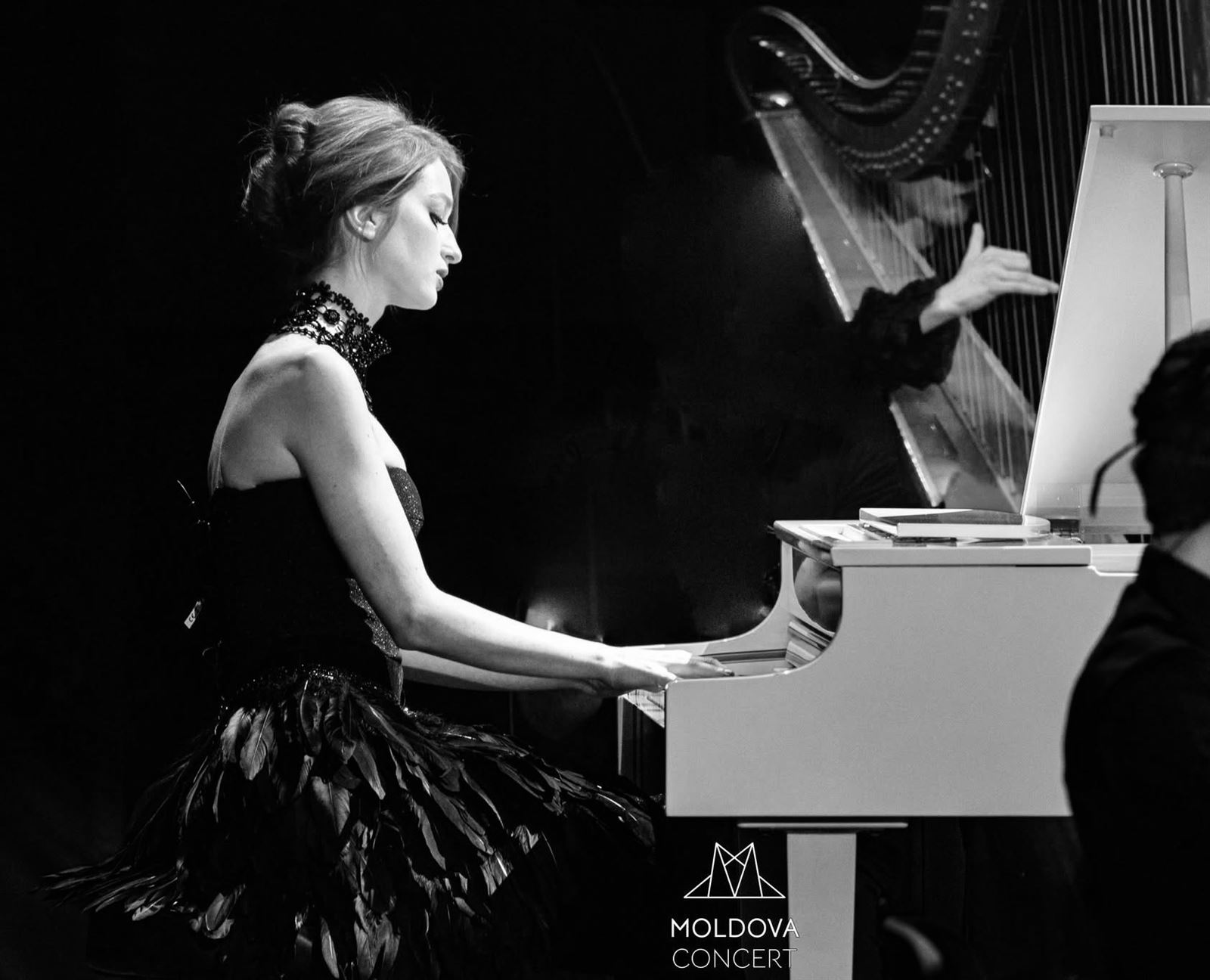Arina Mura performing piano on stage with harp accompaniment, Moldova Concert