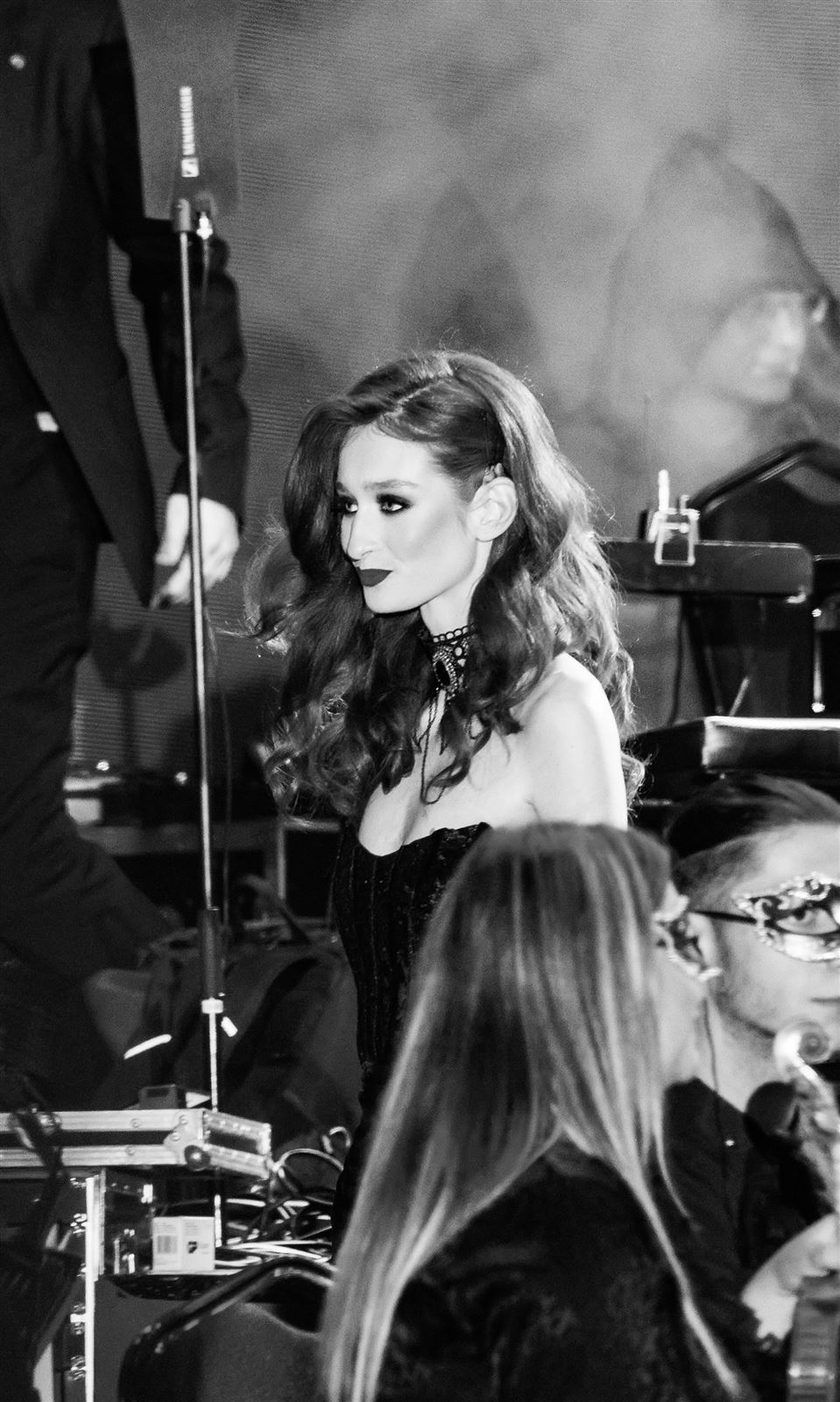 Arina Mura backstage among stage equipment, candid moment